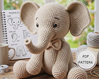 May include: A crocheted elephant toy in beige yarn, with large ears and a bow tie. The elephant is seated, with a pattern book and yarn spools nearby. The book shows diagrams for the amigurumi elephant. A PDF pattern is available.