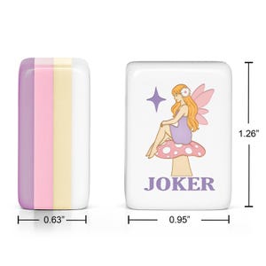 May include: Two rectangular mahjong tiles. One tile shows a side view with vertical stripes of purple, pink, and yellow. The other tile features a white face with a graphic of a fairy sitting on a mushroom, a purple star, and the text JOKER. Dimensions are 1.26 inches by 0.95 inches by 0.63 inches.