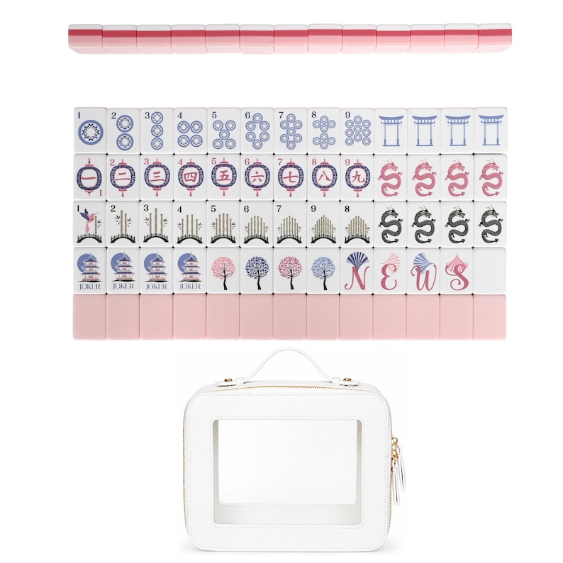 May include: A set of white Mahjong tiles with pink backs, featuring various blue, pink, and black printed designs including numbers, dragons, flowers, and the letters N, E, W, S. The set includes a white rectangular carrying case with a clear window.