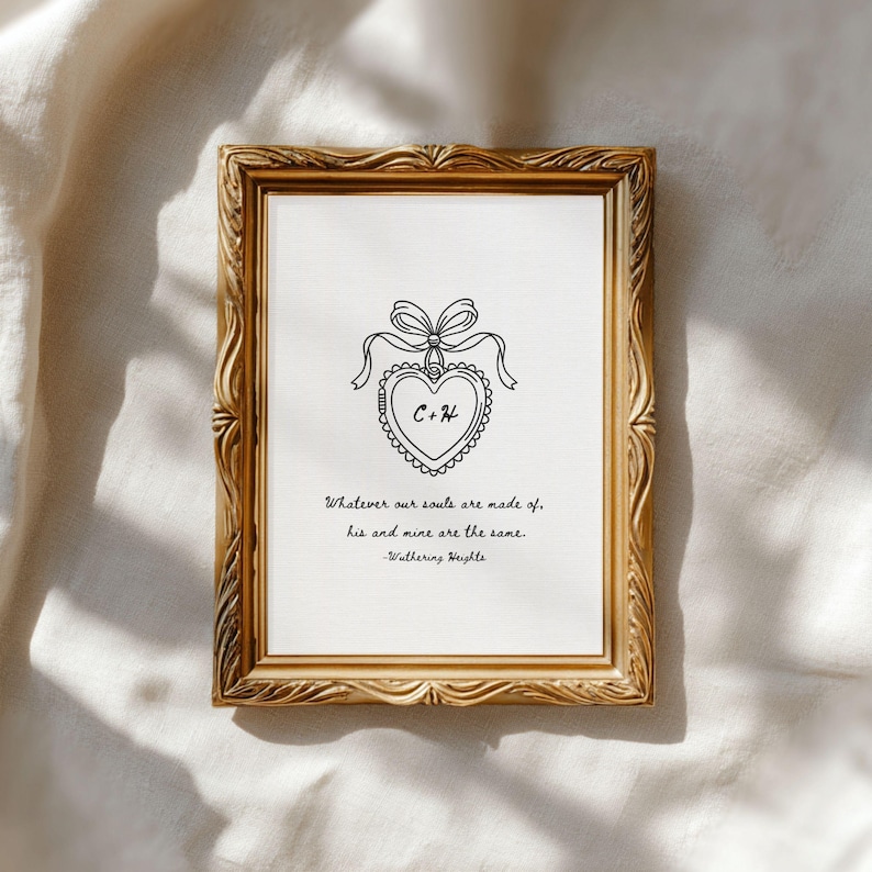 Vintage frame lays on muslin cloth to display a Wuthering Heights print with the quote 'Whatever our souls are made of, his and mine are the same." A concept rendering of a locket with "C" and "H" for the main characters is in the middle.