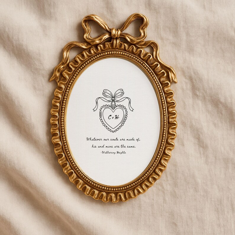 Vintage frame lays on muslin cloth to display a Wuthering Heights print with the quote 'Whatever our souls are made of, his and mine are the same." A concept rendering of a locket with "C" and "H" for the main characters is in the middle.