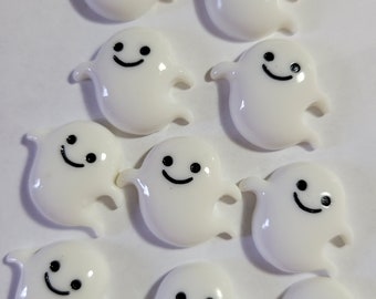 May include: Ten white ghost-shaped resin embellishments with black painted eyes and smiles. The ghosts are approximately 1 inch in size.