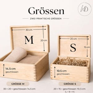 May include: Two open wooden boxes, labeled "M" and "S", with dimensions indicated in centimeters. The larger box contains a rolled beige towel and a folded cloth. The smaller box is filled with shredded paper.