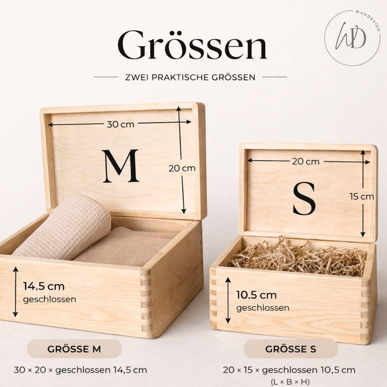 May include: Two open wooden boxes, labeled "M" and "S", with dimensions indicated in centimeters. The larger box contains a rolled beige towel and a folded cloth. The smaller box is filled with shredded paper.