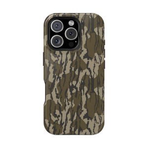 May include: A protective phone case with a camouflage pattern in shades of brown, green, and black. The case has a glossy finish and a raised edge around the camera lenses.