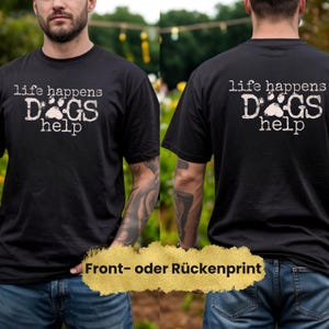 K&ouml;nnte beinhalten: Schwarzes T-Shirt mit dem wei&szlig;en Text "life happens, DOGS help". Das Shirt hat ein Pfotenabdruck-Design. Das Bild zeigt die Vorder- und R&uuml;ckseite des Shirts. Das Shirt ist ein Freizeitartikel.