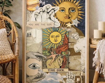 May include: A framed collage featuring tarot card imagery. The artwork includes a large sun face, a hand with stars, and the text "YOU ARE THE SUN" and "THE SUN." The color palette is warm, with yellows, blues, and beige tones.