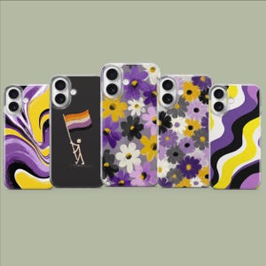 May include: A collection of five phone cases. The cases feature various designs, including floral patterns in purple, yellow, and white, and a black case with a person holding a non-binary pride flag. The cases are made of a clear material.