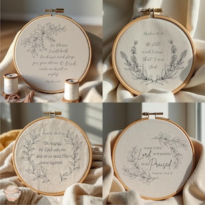May include: Four round embroidery hoops with inspirational quotes and floral designs. Each hoop features a different quote from the Bible, with delicate black line art of flowers and leaves. The hoops are set against a neutral fabric background.