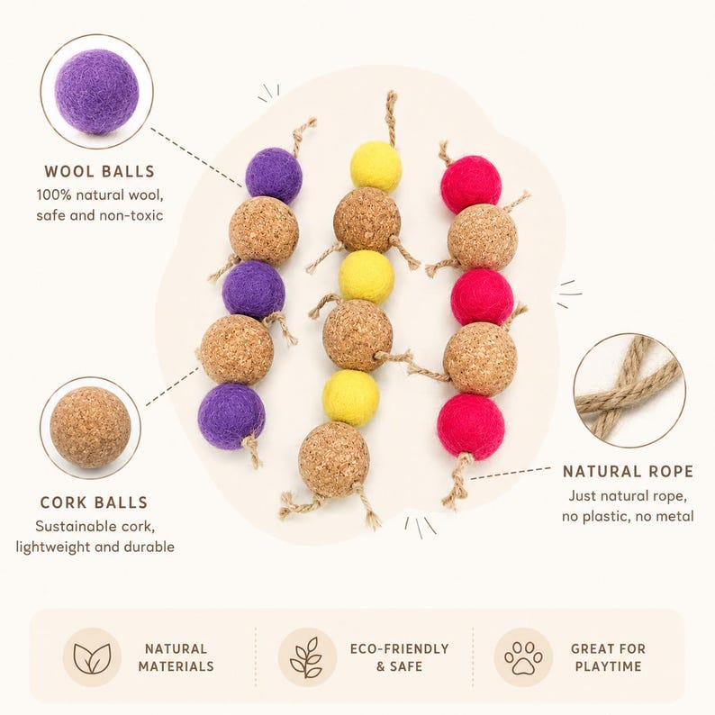 May include: A cat toy featuring strands of wool balls in purple, yellow, and red, interspersed with cork balls. The toy is strung together with natural rope. The text on the image says "Natural Materials", "Eco-Friendly & Safe", and "Great for Playtime".