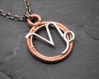 Capricorn necklace wire wrapped in sterling silver and polished copper zodiac