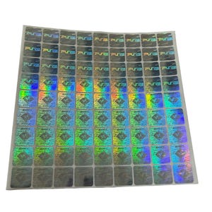 May include: Sheet of holographic stickers with a repeating pattern. Each square sticker has a diamond design and the text "ps2". The stickers have a shiny, iridescent finish, reflecting multiple colors.