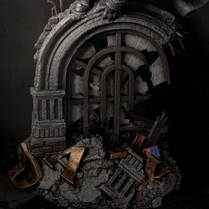 May include: A detailed statue depicting a crumbling architectural structure with a broken arched window. The statue features a figure in a dark coat and boots, perched atop the structure. The color palette is primarily gray, brown, and bronze, with a Rubik's Cube visible.
