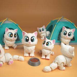 May include: A collection of white cat figurines with large blue eyes and pink accents, posed near small teal tents. A gray bowl with brown food sits in front of the cats. The background is a solid tan color.