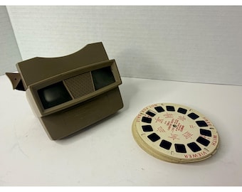 Visor 3D Sawyers View-Master Modelo E color beige, 15 carretes, lote de Disneyland Europa.