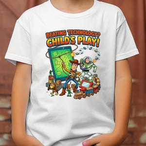 May include: White t-shirt featuring a colorful graphic of Woody and Buzz Lightyear from Toy Story. The design includes a tablet, a train, and the text "BEATING TECHNOLOGY? CHILD'S PLAY!"