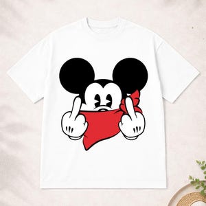 May include: White t-shirt featuring a cartoon mouse with black ears, a red bandana, and two fingers raised in a rude gesture. The mouse's face is visible, with a black nose and white eyes. The shirt is a casual, unisex style.