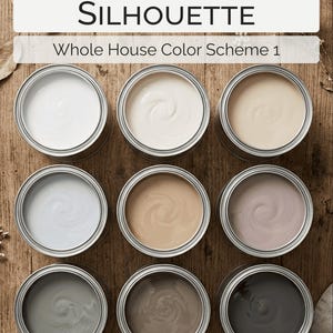 May include: Nine open paint cans with various shades of neutral colors, including white, beige, gray, and brown, arranged on a wooden surface. The text "Benjamin Moore SILHOUETTE Whole House Color Scheme 1" is displayed at the top.