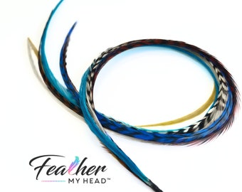 May include: Two long blue, black, white, and brown feathers with a black cord attached to the end. The feathers are arranged in a circle shape. The text "Feather My Head" is visible in the bottom left corner of the image.