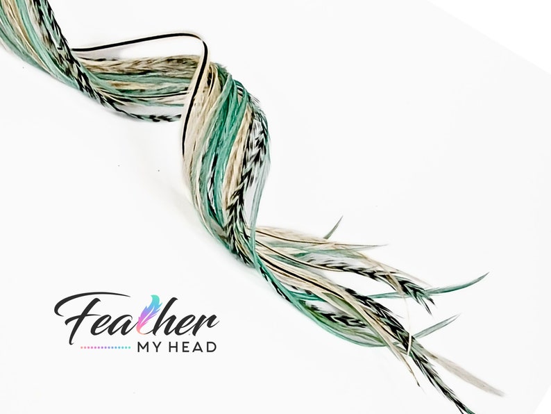 May include: A bundle of long, white, green, and black feathers. The feathers are arranged in a spiral shape. The text "Feather My Head" is visible in the lower left corner of the image.