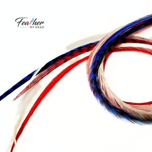 Close up of extra long hand dyed red white and blue hair feathers, salon grade and reusable