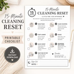 May include: A white printable checklist titled 15-Minute Cleaning Reset with black text and icons. It lists seven tasks including grab trash, clear counters, start laundry, dishes, quick sweep, bathroom wipe-down, and reset one hot spot with checkboxes.