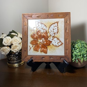 May include: A handmade, wooden serving tray with a natural finish. The tray features a rectangular shape with rounded corners and two carved handles. The wood grain is visible, adding to its rustic charm. Perfect for serving food or displaying items.