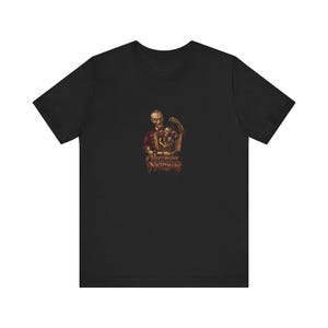 May include: A black short-sleeved t-shirt featuring a central graphic of a sinister figure holding a smaller version of itself, which in turn holds an even smaller figure. The text "RECURSIVE NIGHTMARE" is printed in a stylized font below the illustration.