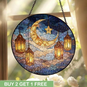 May include: Round stained glass window art featuring a crescent moon, star, and hanging lanterns. The design incorporates shades of blue, gold, and brown, with a cloudy sky background. The text "BUY 2 GET 1 FREE" is at the bottom.