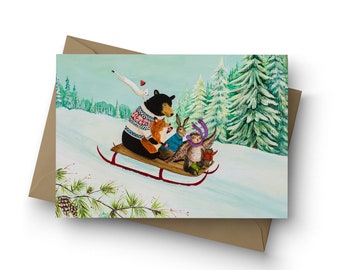 May include: A black bear wearing a red and white sweater pulls a red sled through a snowy forest. A fox, rabbit, and owl are riding on the sled with the bear.