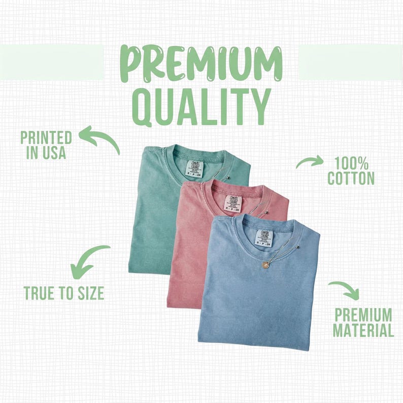 May include: Three folded t-shirts in shades of teal, pink, and blue. The image includes text that reads "Premium Quality", "Printed in USA", "True to Size", "100% Cotton", and "Premium Material".