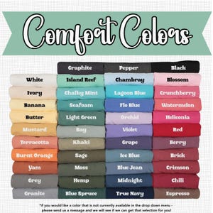 May include: A color chart featuring a variety of Comfort Colors t-shirts. The chart displays a range of colors, including white, black, blue, green, and red. The text "Comfort Colors" is at the top of the image.
