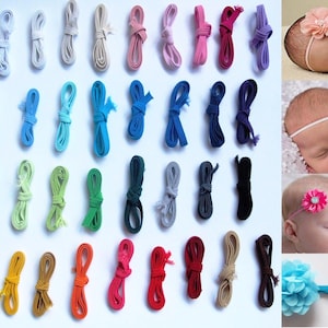 May include: A selection of colourful ribbons and baby headbands. The ribbons are in various shades, including white, blue, green, yellow, orange, pink, red, and brown. The headbands feature flower and bow accents, suitable for infants.
