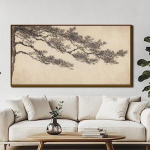 May include: A rectangular wall art piece featuring a detailed charcoal-style illustration of a pine tree branch extending horizontally across a light beige background, enclosed within a thin, dark brown wooden frame mounted on a wall.