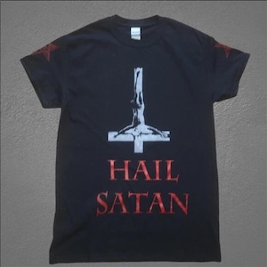 May include: Black t-shirt featuring a white inverted cross with a figure and the words "HAIL SATAN" in red. Red star shapes are on the shoulders. A dark, edgy design.