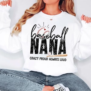 May include: White sweatshirt with the words "baseball NANA" in black, with a baseball graphic. The text "CRAZY PROUD ALWAYS LOUD" is below the main text. The sweatshirt has long sleeves.