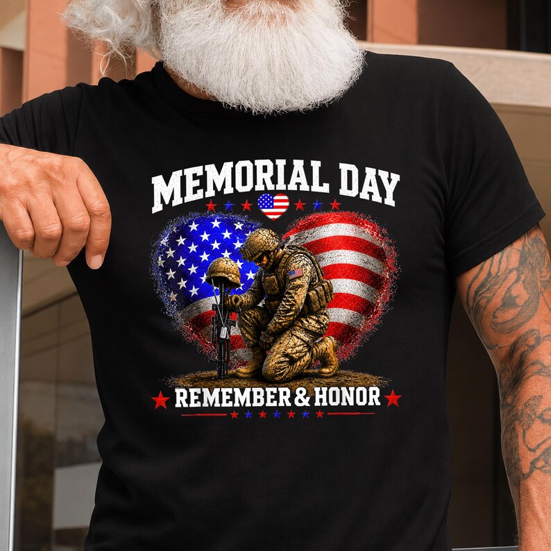 May include: Black t-shirt with a patriotic Memorial Day design. The graphic features a kneeling soldier, a helmet, and a rifle, set against a heart-shaped American flag. The text reads "MEMORIAL DAY" and "REMEMBER & HONOR" in white.