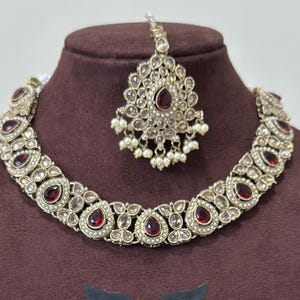 May include: A set of three ceramic mugs with a speckled, matte finish. The mugs are in shades of cream, light grey, and dark grey. Each mug has a simple, minimalist design, ideal for coffee or tea.