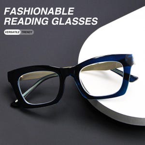 May include: Dark blue reading glasses with thick rectangular frames and clear lenses. The text FASHIONABLE READING GLASSES and VERSATILE TRENDY is visible at the top. The glasses feature a glossy finish and a sturdy bridge design.