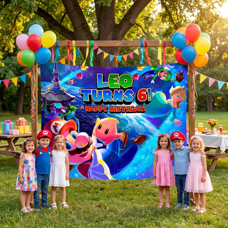 May include: A rectangular birthday banner featuring a space-themed background with Mario characters, the text 'LEO TURNS 6! HAPPY BIRTHDAY', and colourful balloons attached to a wooden frame, displayed outdoors in a grassy area.