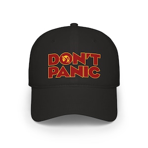 May include: Black baseball cap with the text "DON'T PANIC" in red and yellow. The cap has a curved peak and a structured crown. The design is a bold, eye-catching statement.