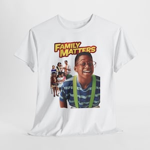 May include: White t-shirt featuring a graphic from the sitcom "Family Matters." The design includes the show's logo in yellow and red, along with a photo of the cast, including a smiling young man wearing glasses and suspenders.