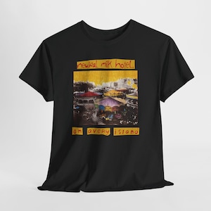 May include: A black short-sleeve t-shirt featuring a graphic print of a carousel scene with a yellow background. The text "neutral milk hotel" appears above the image and "on avery island" appears below in a handwritten red font style.