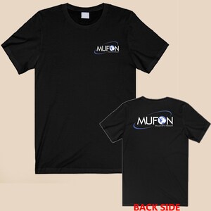 May include: A black short-sleeved t-shirt featuring the MUFON Mutual UFO Network logo on the front left chest and a larger version of the same logo on the back. The logo consists of the text MUFON with a blue globe and a blue orbital ring.