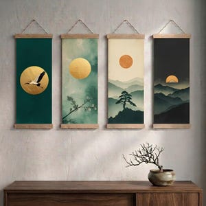 May include: A set of four vertical wall hangings featuring wooden frames and hanging cords. Each print displays a nature-inspired scene with a circular gold sun, including a crane in flight, a leafy branch, a pine tree, and a mountain range.