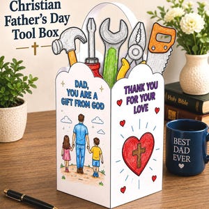 Op de afbeelding: Een witte papieren gereedschapskist met een handvat en illustraties van een hamer, schroevendraaier, moersleutel, tang en zaag. De doos bevat de tekst "Dad, you are a gift from God" en "Thank you for your love" met een hart- en kruisafbeelding.