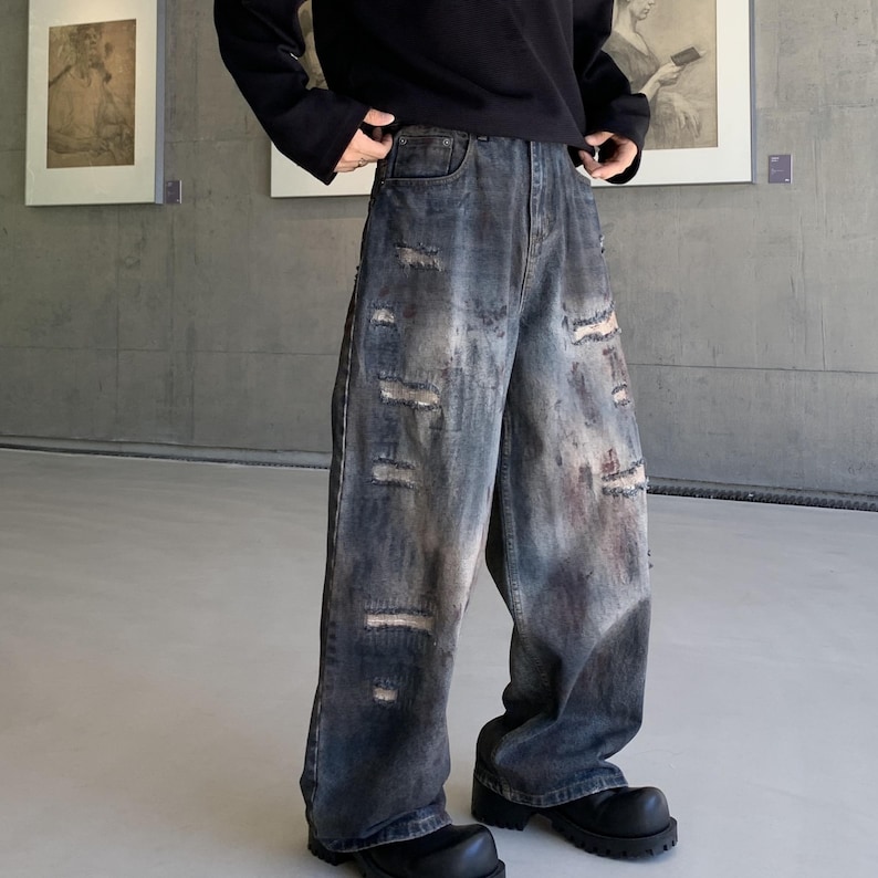 Distressed Denim Jeans | Washed Ripped Wide Leg Pants | Casual Wear | Urban Street Style

Dark washed wide-leg denim jeans with heavy distressed fading and ripped details, featuring a loose straight fit and rugged streetwear style.