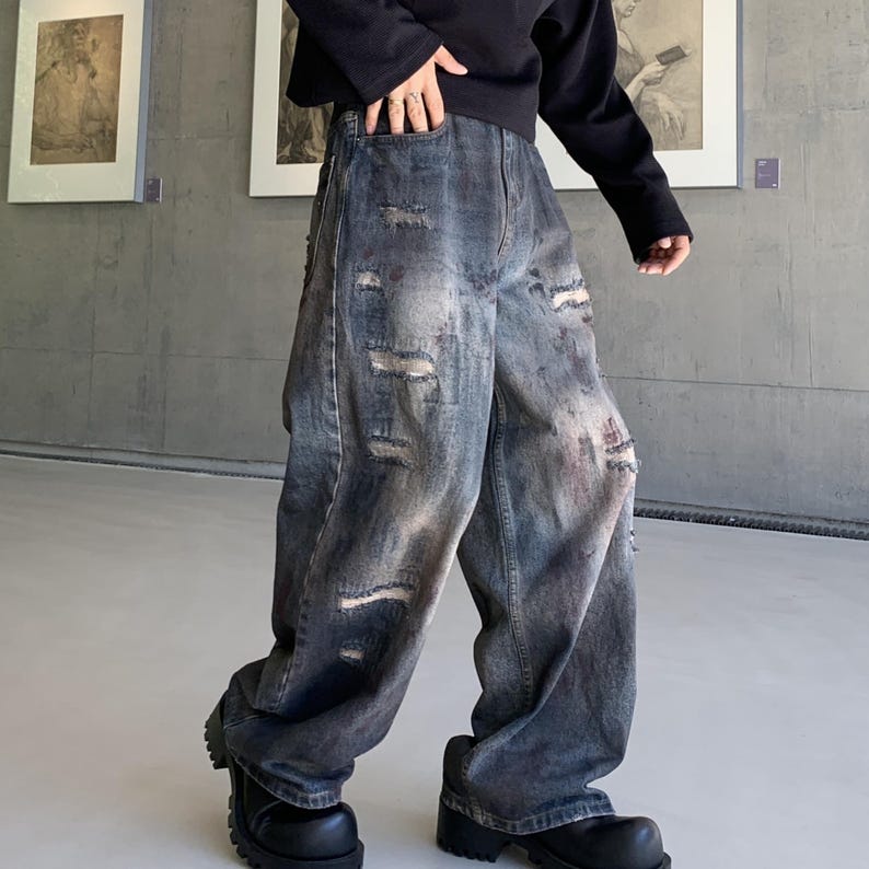 Distressed Denim Jeans | Washed Ripped Wide Leg Pants | Casual Wear | Urban Street Style

Dark washed wide-leg denim jeans with heavy distressed fading and ripped details, featuring a loose straight fit and rugged streetwear style.
