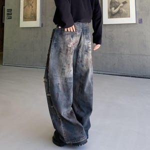 Distressed Denim Jeans | Washed Ripped Wide Leg Pants | Casual Wear | Urban Street Style

Dark washed wide-leg denim jeans with heavy distressed fading and ripped details, featuring a loose straight fit and rugged streetwear style.