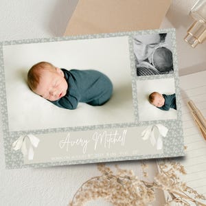 May include: A birth announcement card with a newborn baby in a dark teal outfit. The card includes a main photo, two smaller photos, and the baby's name, birth date, weight, and length. The card has a floral border and ribbon accents. The baby's length is 51 cm.